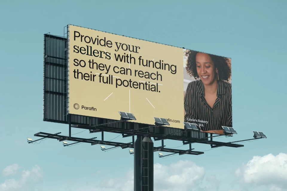 Billboard advertising Parafin services with the image of a smiling woman business owner and text about funding for sellers.