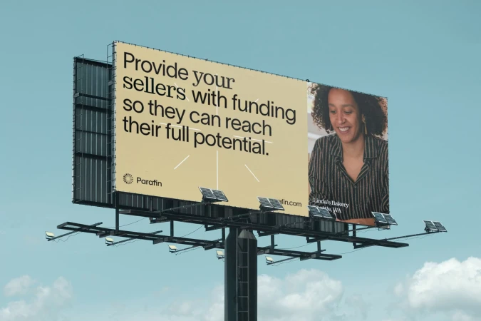 Billboard advertising Parafin services with the image of a smiling woman business owner and text about funding for sellers.
