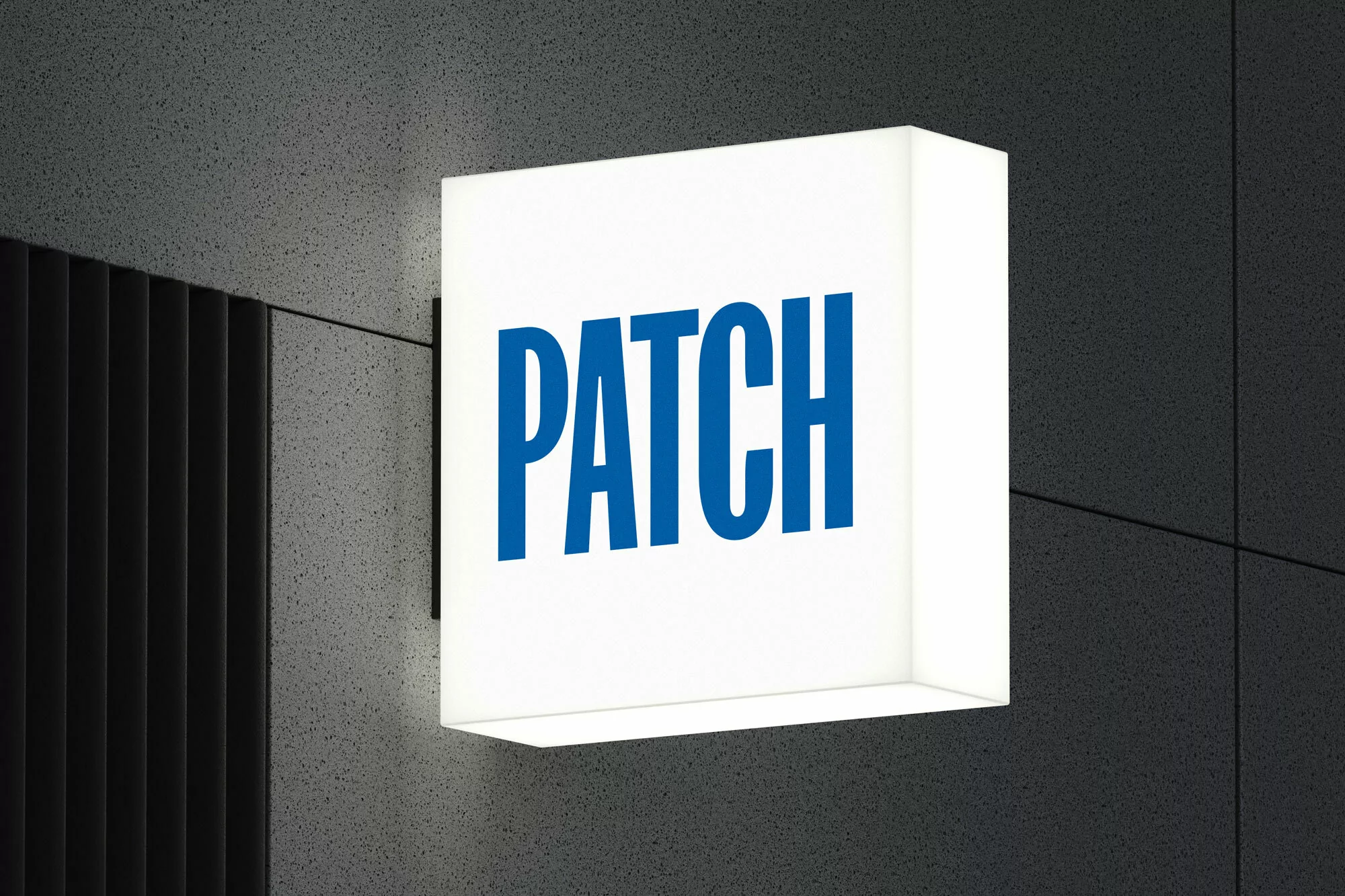 Illuminated cube sign with the word PATCH in blue, mounted on a textured gray wall with black vertical slats to the side.