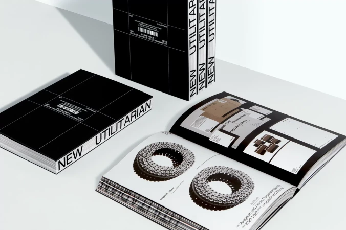 Black and white 'New Utilitarian' book set featuring a stack of closed books and an open book revealing product design pages.
