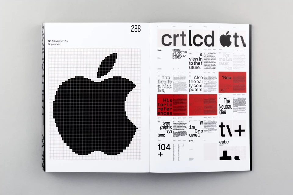 Open book displaying an Apple logo graphic design in pixel art on one page and typographic design layouts on the opposite page.