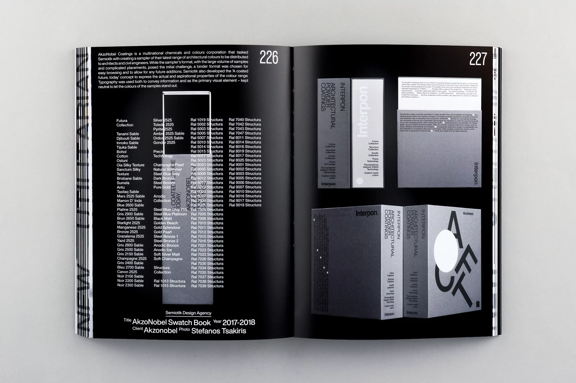 Open pages of an AkzoNobel swatch book showcase architectural powder coatings and designs, photographed indoors with a neutral gray background.