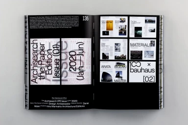 An open magazine layout featuring bold typographic cover design and editorial grid layouts on black pages by victionary.