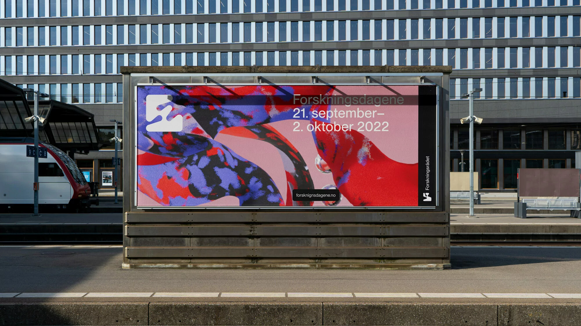 Outdoor advertising billboard with abstract art at a train station. The poster features an abstract design and text promoting research.