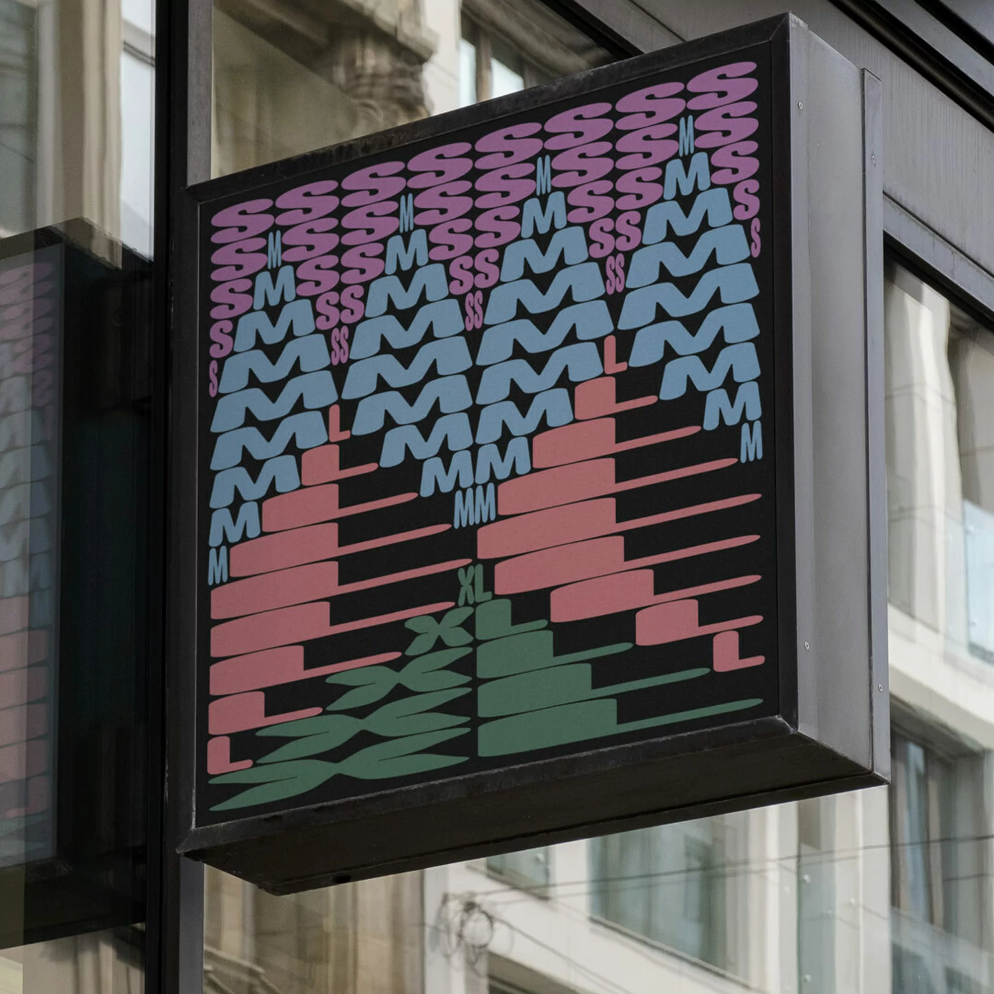 Storefront sign with stylized lettering displaying clothing sizes from S to XL in pastel shades of pink, blue, and green.