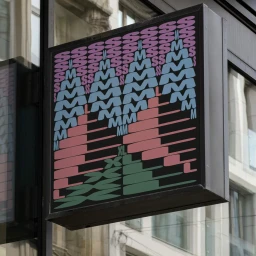 Square brand identity sign for smlXL featuring repeating typographical letterforms in pink, blue, and green on a dark background.