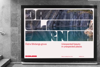 Billboard displaying Dalarna brand identity with photographic typography showing a rocky quarry and reflective water lake.