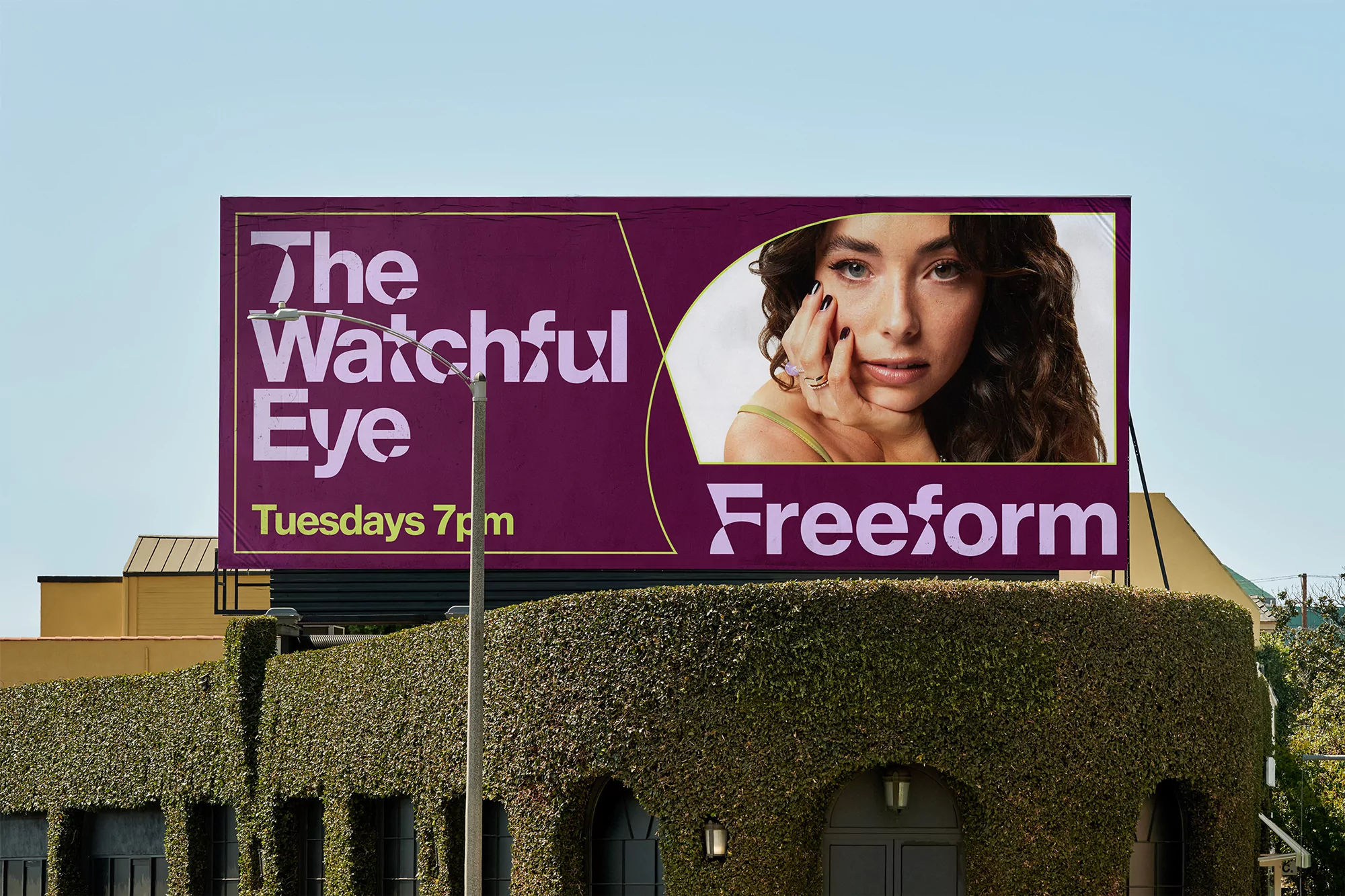 Billboard advertisement for The Watchful Eye show on Freeform featuring a woman against a plum background with the show title.