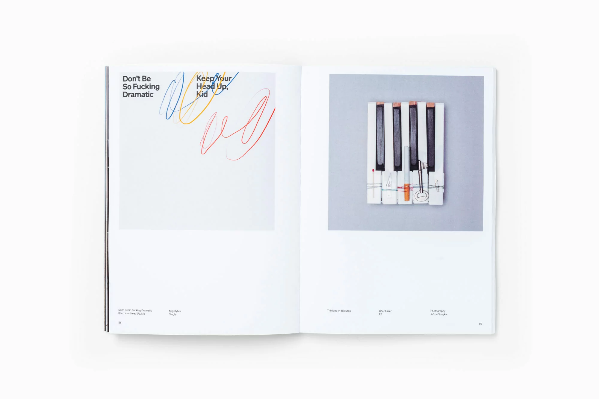 Opened book with artful graphic design featuring colorful typography and a stylized piano keyboard against a clean, white backdrop.