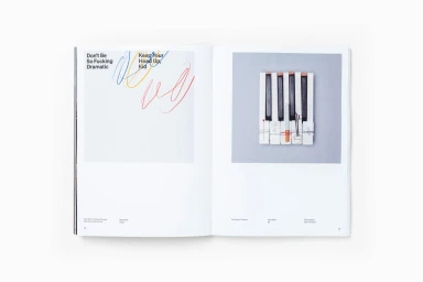 Open book spread showing graphic design layout with colorful abstract scribbles and a photograph of piano keys bound with string.