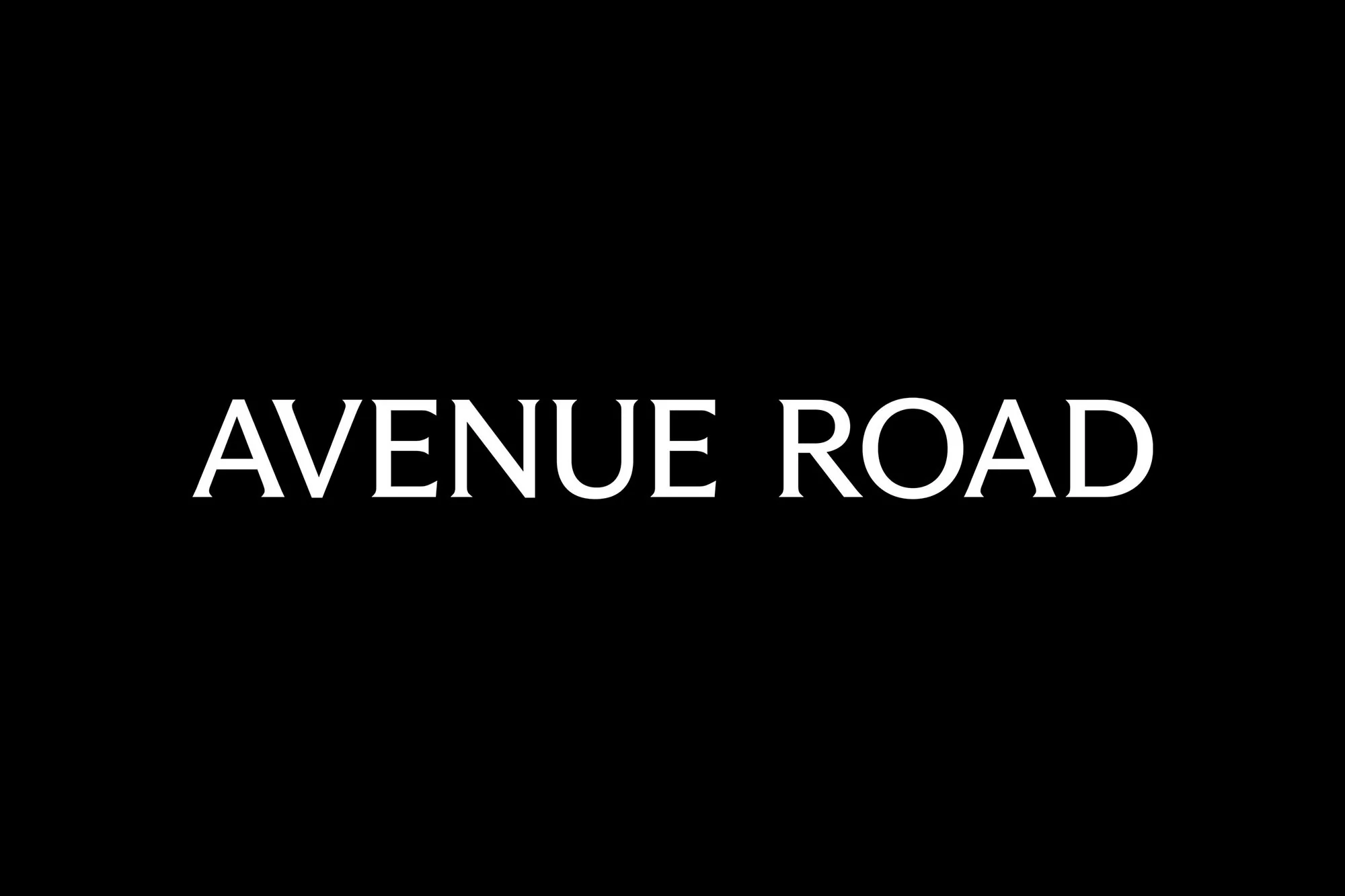White text 'Avenue Road' displayed against a solid black background, creating a simple and impactful graphic design with clear typography.
