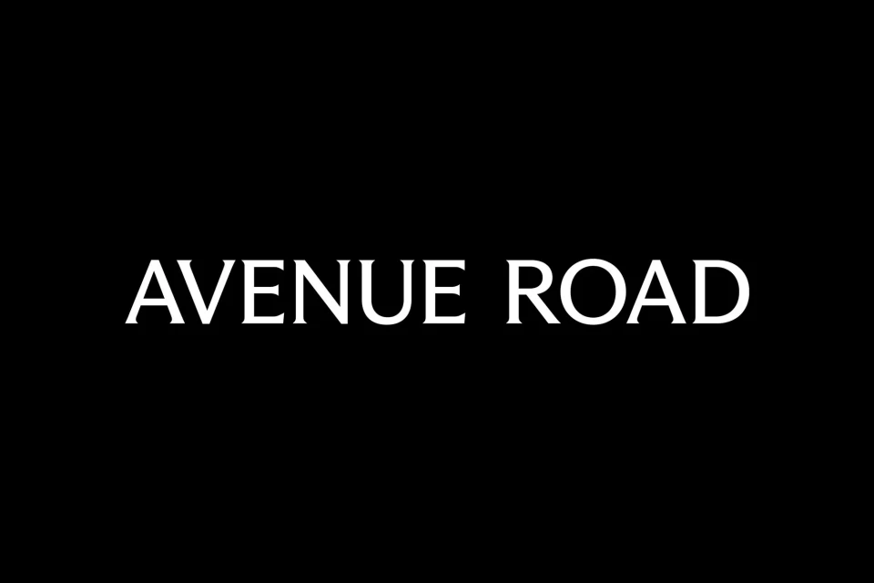 White text 'Avenue Road' displayed against a solid black background, creating a simple and impactful graphic design with clear typography.