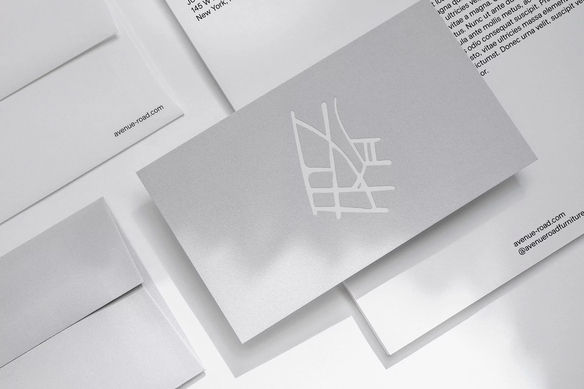 Close-up of stationery suite featuring business card with logo, envelopes, and letterhead, all in a clean, modern, minimalist style.