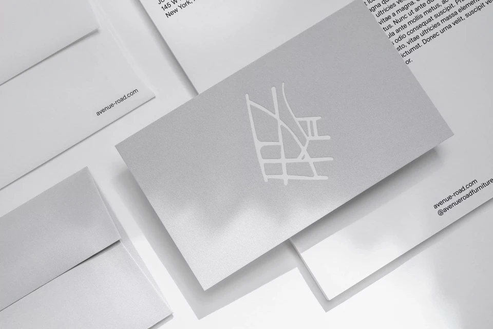 Close-up of stationery suite featuring business card with logo, envelopes, and letterhead, all in a clean, modern, minimalist style.
