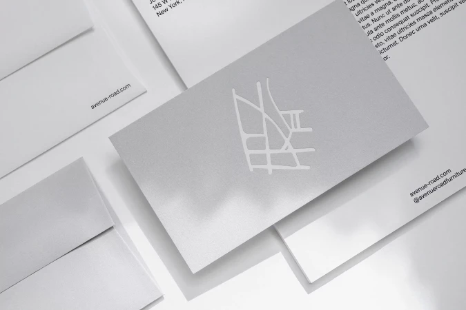 Close-up of stationery suite featuring business card with logo, envelopes, and letterhead, all in a clean, modern, minimalist style.