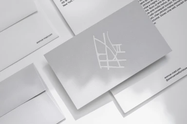 Avenue Road brand stationery featuring a grey business card with white logo resting on matching envelopes and letterheads