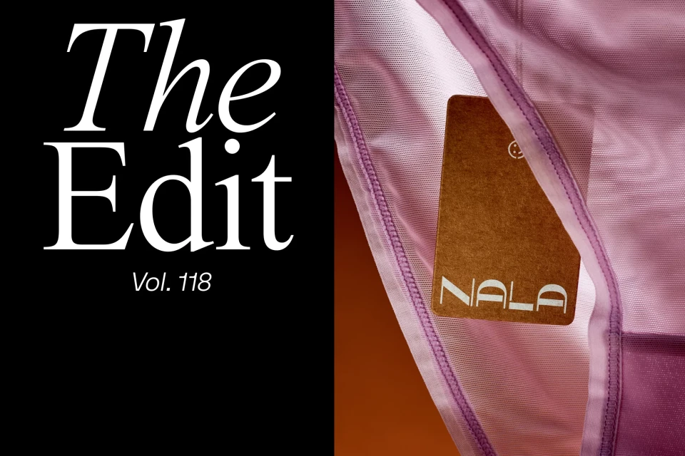 Close-up of a pink, sheer lingerie item with a brown Nala tag attached, contrasted against a black background with white text.