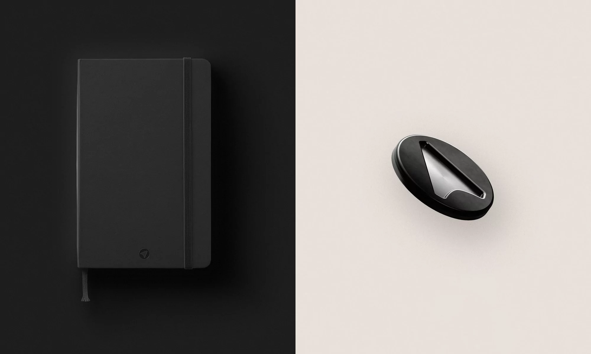 Monochrome flat lay of a closed black notebook with elastic closure beside a black and silver metal object on a split background.