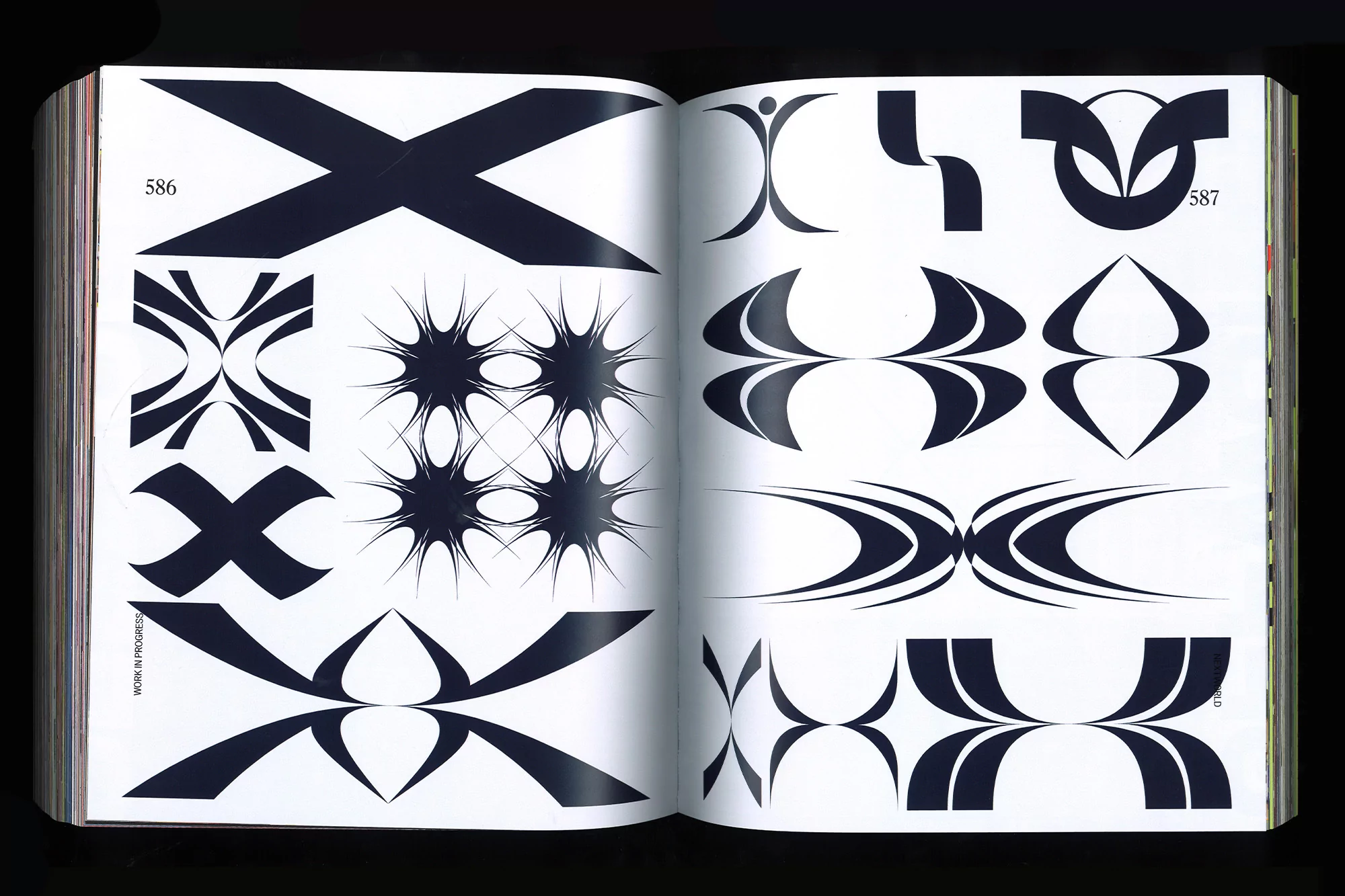 Open book displaying black and white graphic design elements including radial, crisscross, and symmetric patterns on facing pages.