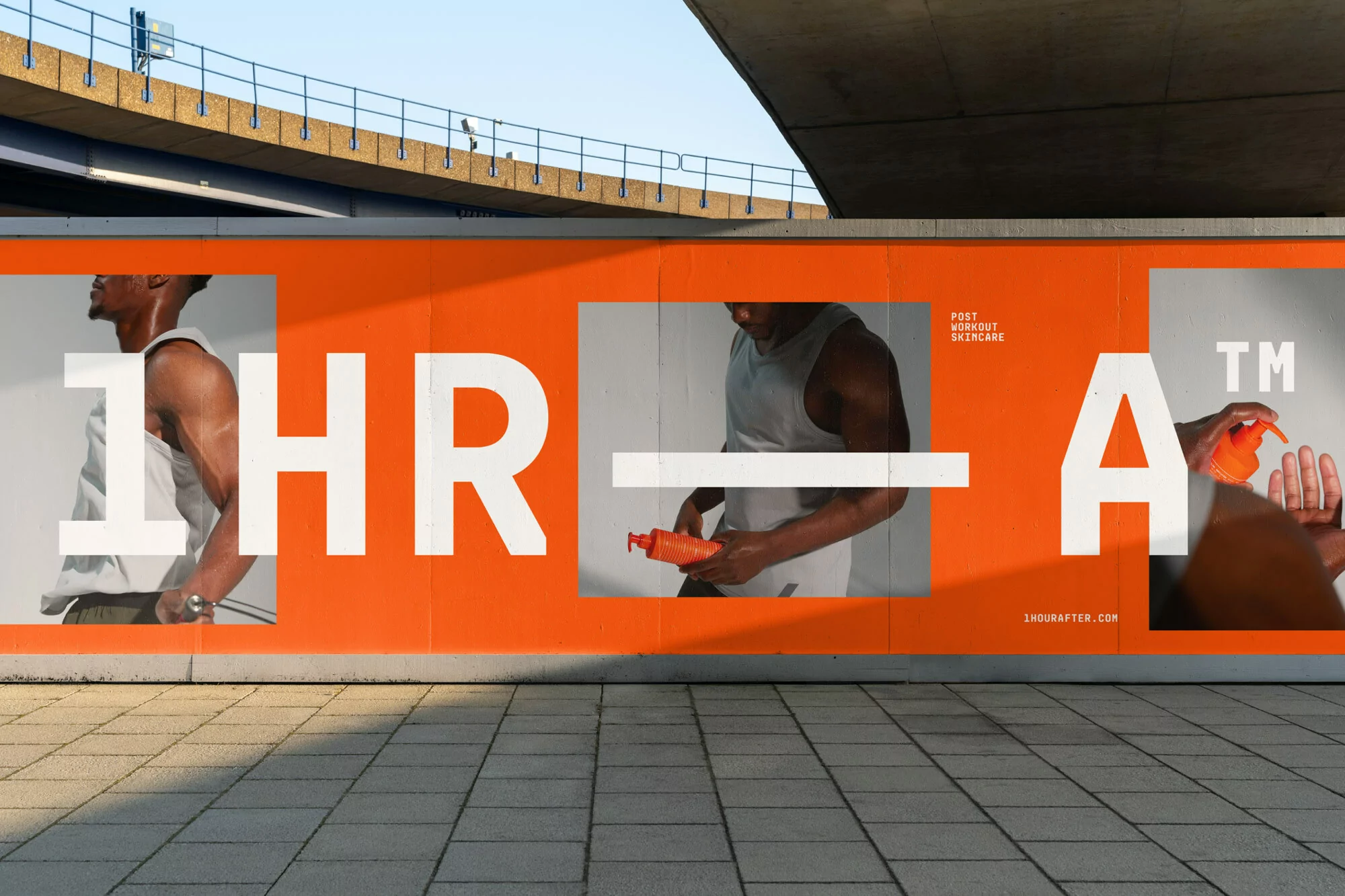 Large orange billboard featuring a post-workout skincare ad with a muscular man, cosmetic bottle, and block-letter typography.