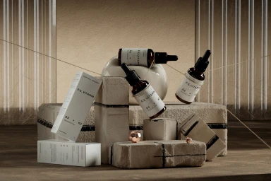 Amber glass dropper bottles and white product boxes arranged on textured stone blocks with string lines