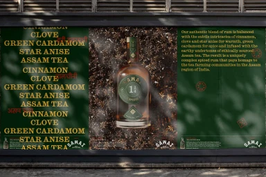 A billboard display featuring a bottle of spiced rum centered against spice backgrounds and text panels.