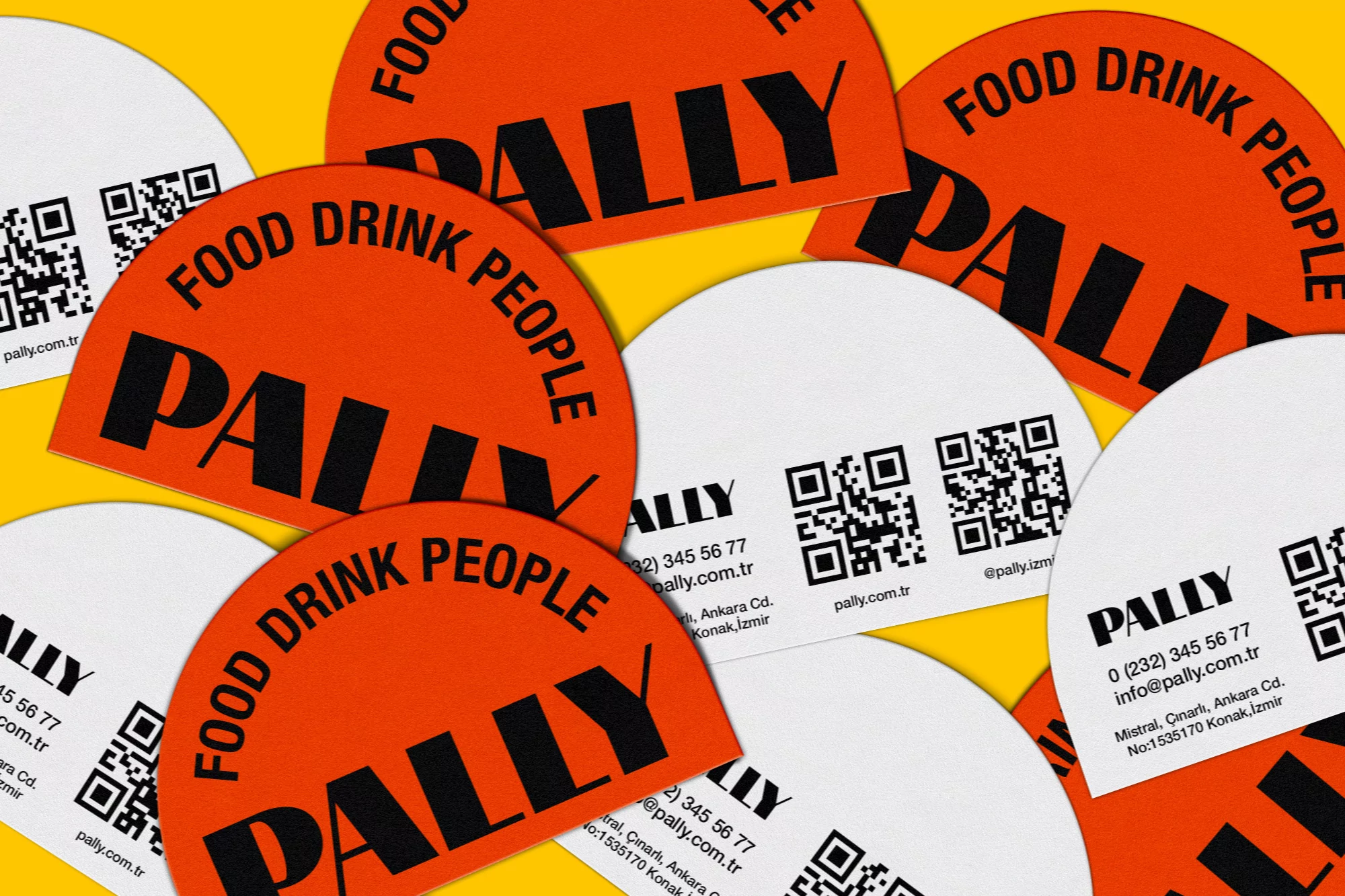 Overhead shot of white and orange semi-circle paper cards with 'Pally' brand name against a solid yellow background.