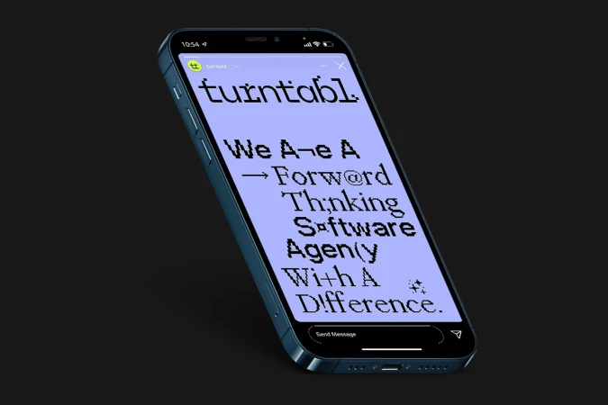 An iPhone displays graphic text: We Are A Forward Thinking Software Agency With A Difference on a purple background, presented against a black backdrop.