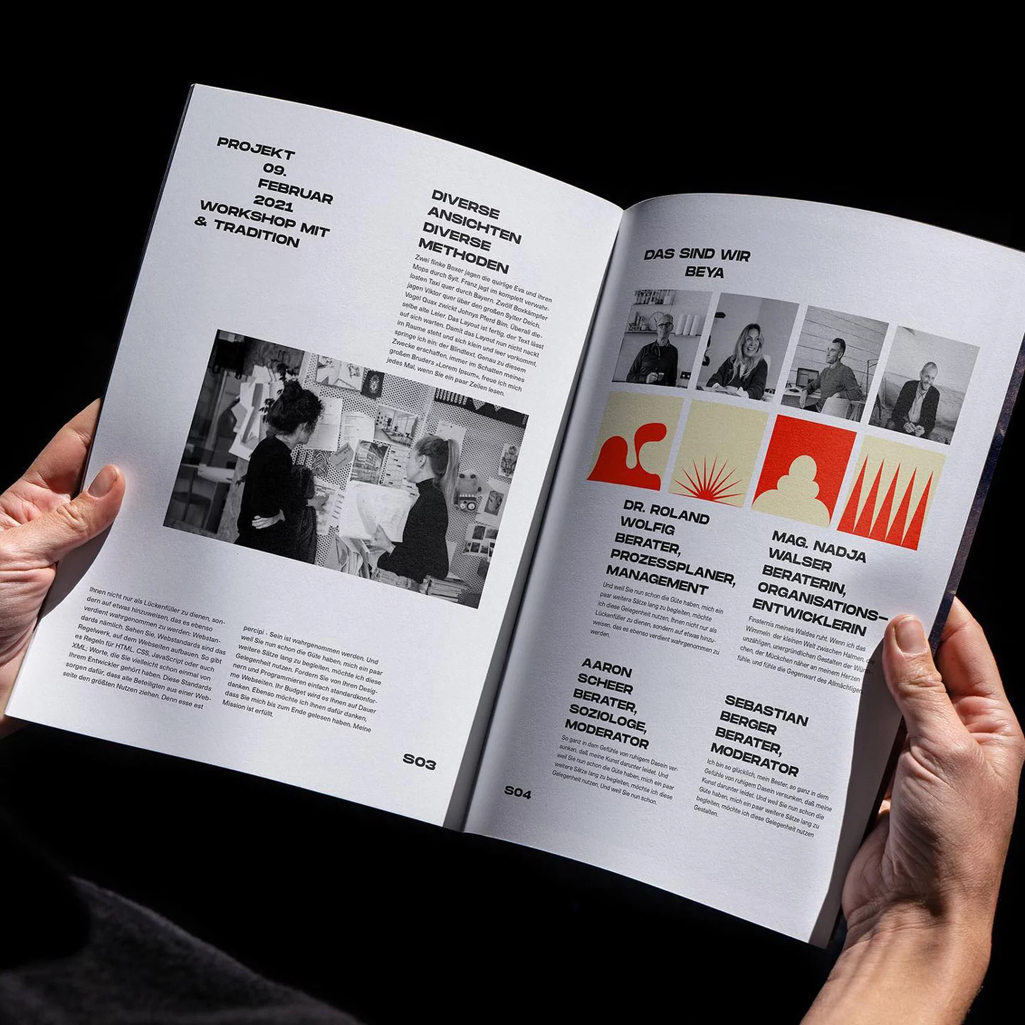 Open magazine spread showing graphic design typography, photographs, and red abstract spot illustrations on white paper pages