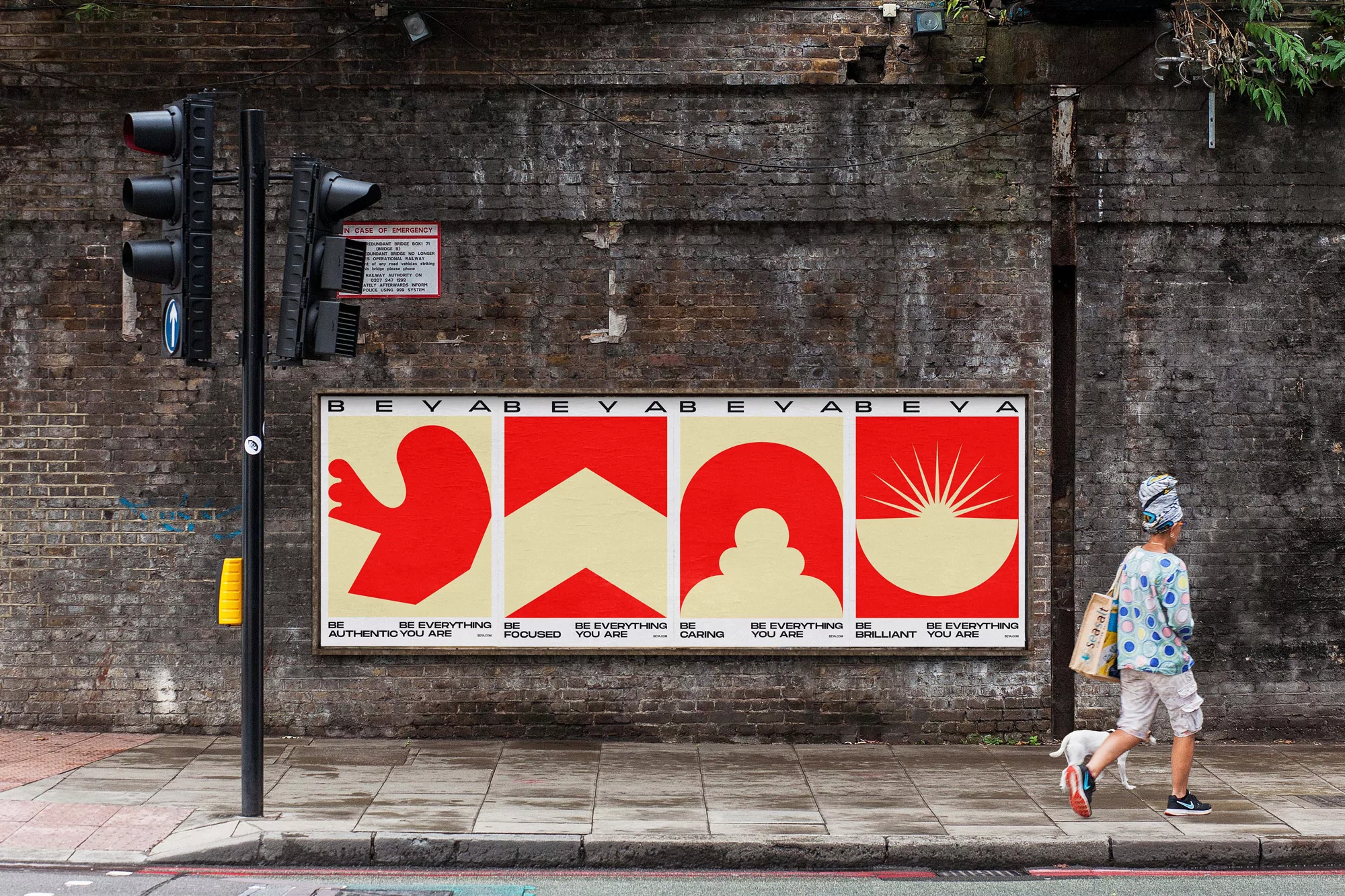 Eye-level shot of a person and dog walking past a red and beige mural on a brick wall along a city sidewalk, featuring the text 'BEVABE'.