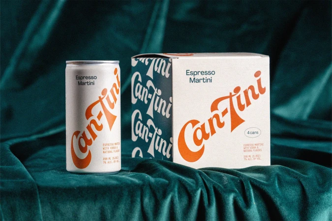 Can-Tini espresso martini can and box on a dark teal velvet surface, showcasing beverage packaging and product presentation.