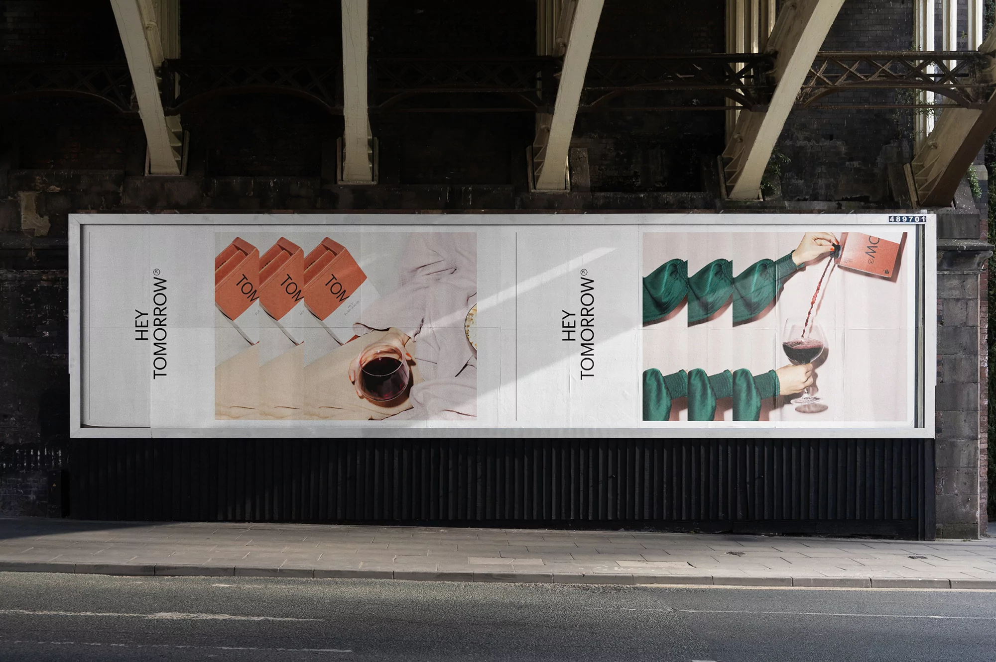 Outdoor billboard advertisement features an image of wine being poured, with the words 'Hey Tomorrow' visible in the background.
