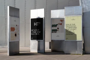 Four large vertical billboard posters displaying brand identity and graphic design for Hey Tomorrow wine outdoors.