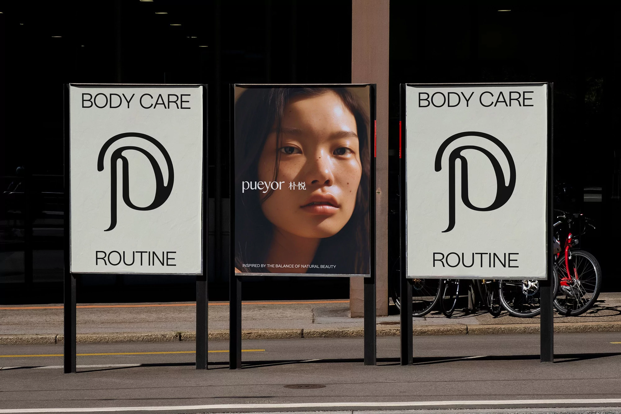 Outdoor advertising displays featuring body care product branding with a woman's portrait and a bicycle parked nearby.