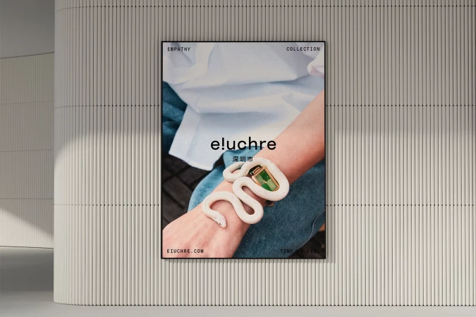 Close-up of a fashion poster showcasing a model's arm with a decorative snake bracelet in an indoor setting with a ribbed wall background.