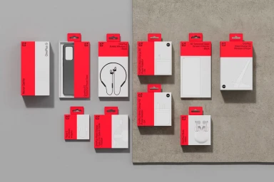 Top-down view of OnePlus product packaging boxes and accessories in red and white displayed flat against a grey surface