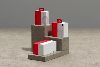 Three OnePlus product boxes arranged on grey concrete blocks against a neutral background