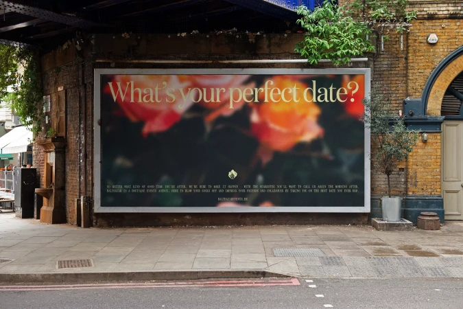 Outdoor advertising billboard for Ballroom is displayed on brick wall with floral pattern, dark background and text overlay in neutral setting.