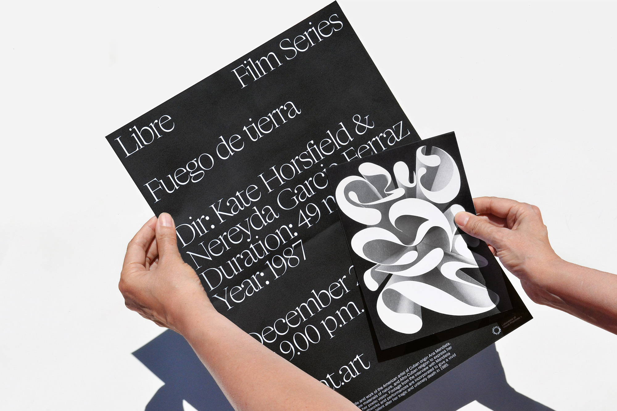 Two hands holding film series posters with bold typography and graphic design in a minimalist, modern style against a white backdrop.