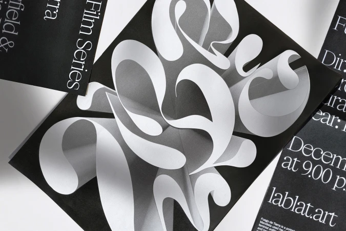 Abstract graphic design featuring curved, paper-like shapes on black, surrounded by film series posters with white text details.