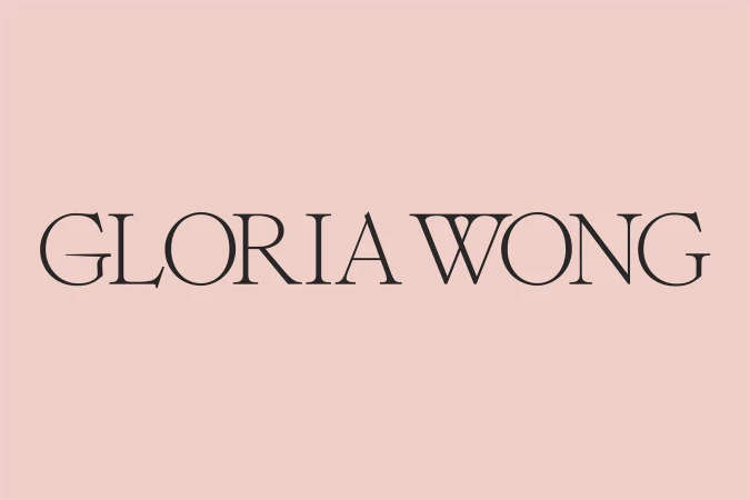 Elegant, minimalist presentation of 'Gloria Wong' in black serif typeface set against a soft peach background, clean and sophisticated.