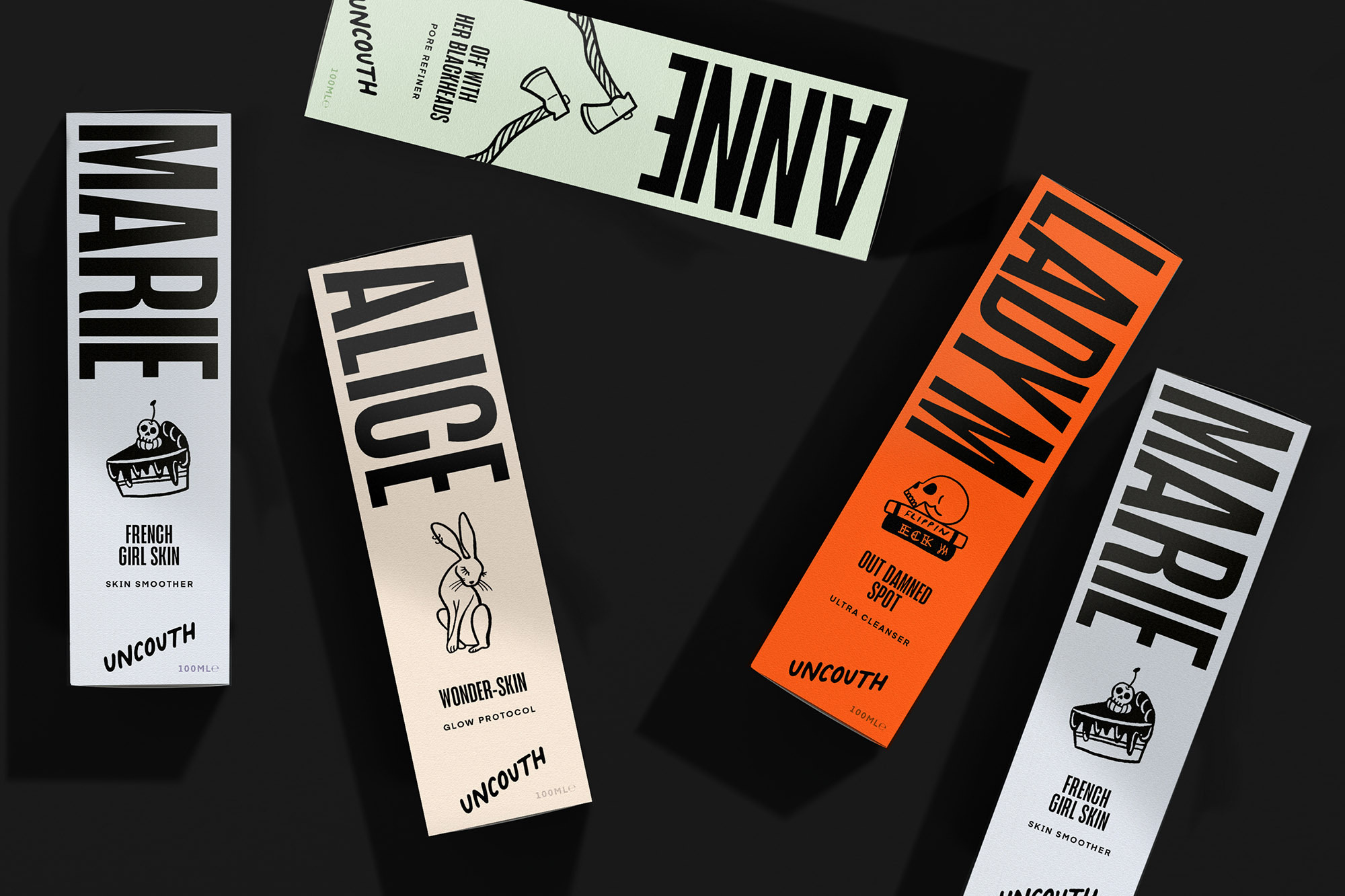 Several colorful Uncouth skincare product boxes, each featuring a different female name and design, are arranged on a black surface.