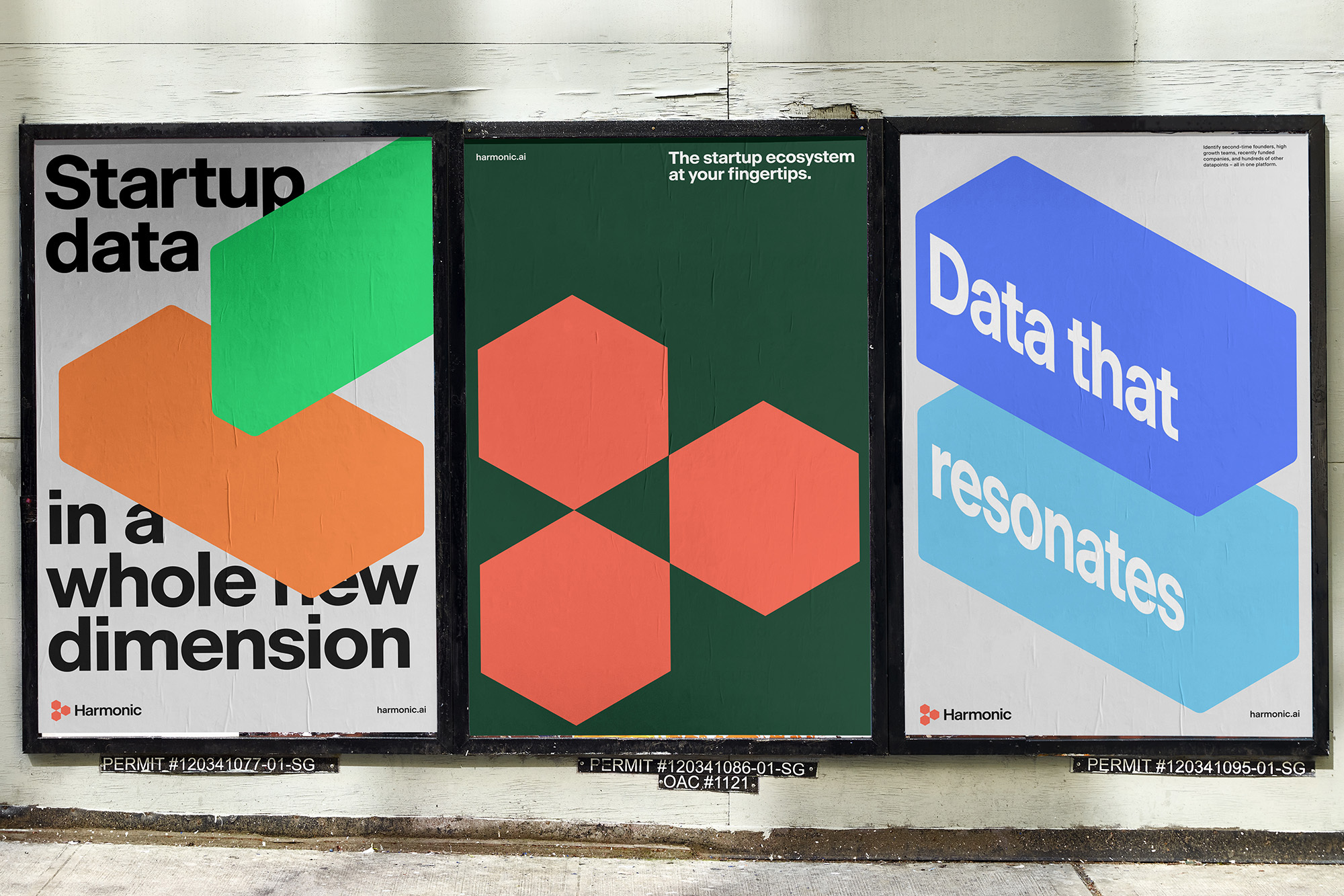 Three marketing posters displayed on a wall. Each poster features modern graphic design with geometric shapes and bold text. 