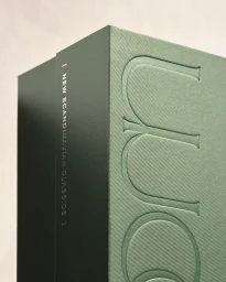 Close-up of a dark green textured box with debossed serif typography and white side text reading new scandinavian classics