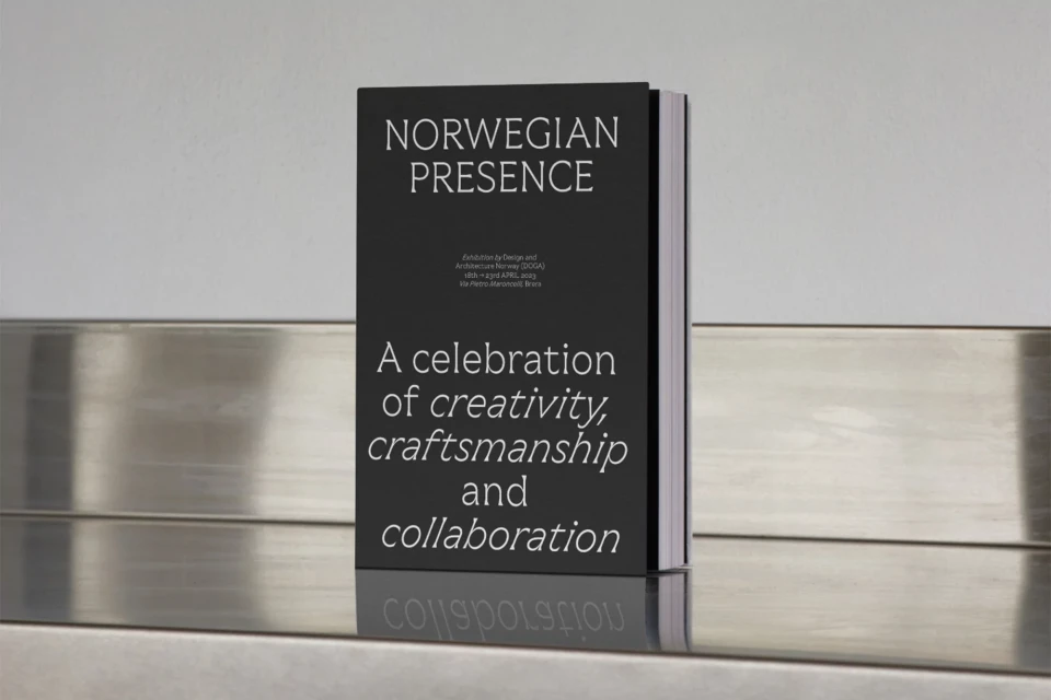 Book cover featuring 'Norwegian Presence' exhibition design. Silver shelf and white wall background. The book has black cover with white text.