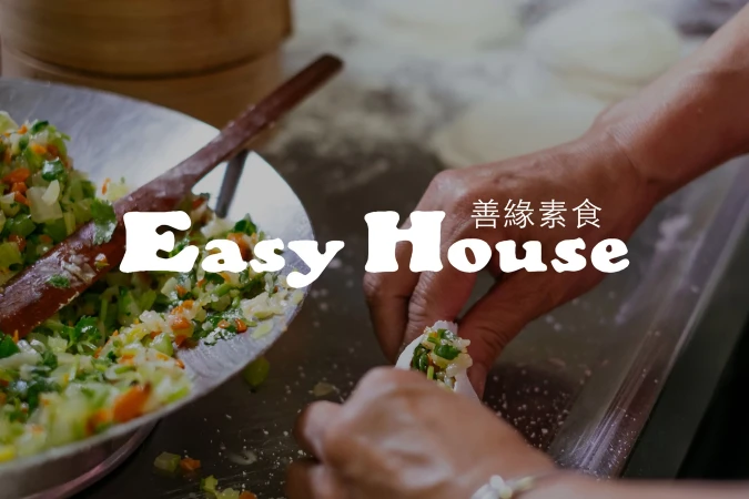 A close-up shot features food preparation: a person filling dumplings with a colorful vegetable mixture. Utensils are visible.
