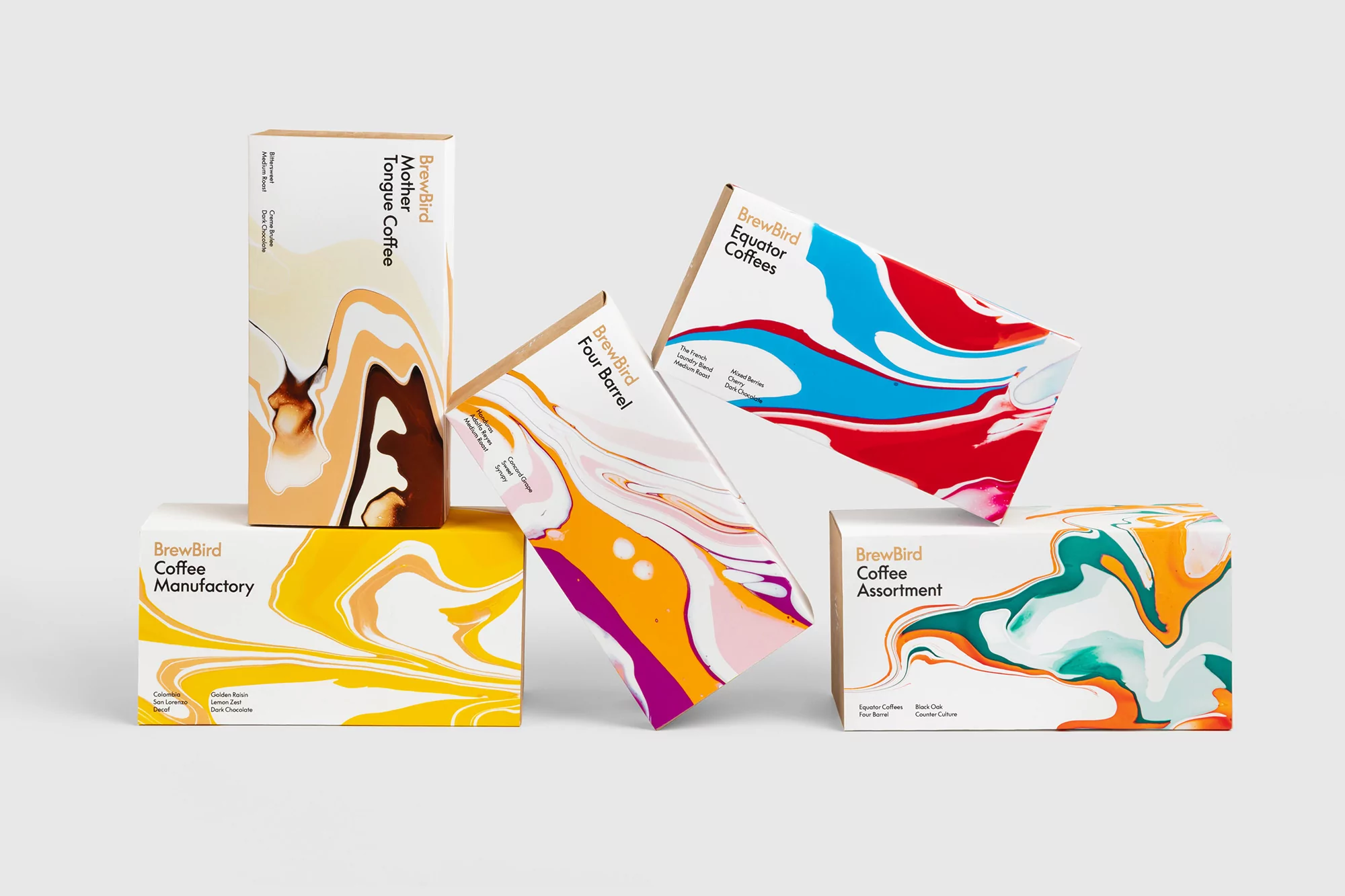 Five colorful BrewBird coffee boxes with abstract fluid art designs stacked on a light gray surface, showcasing beverage packaging and branding.