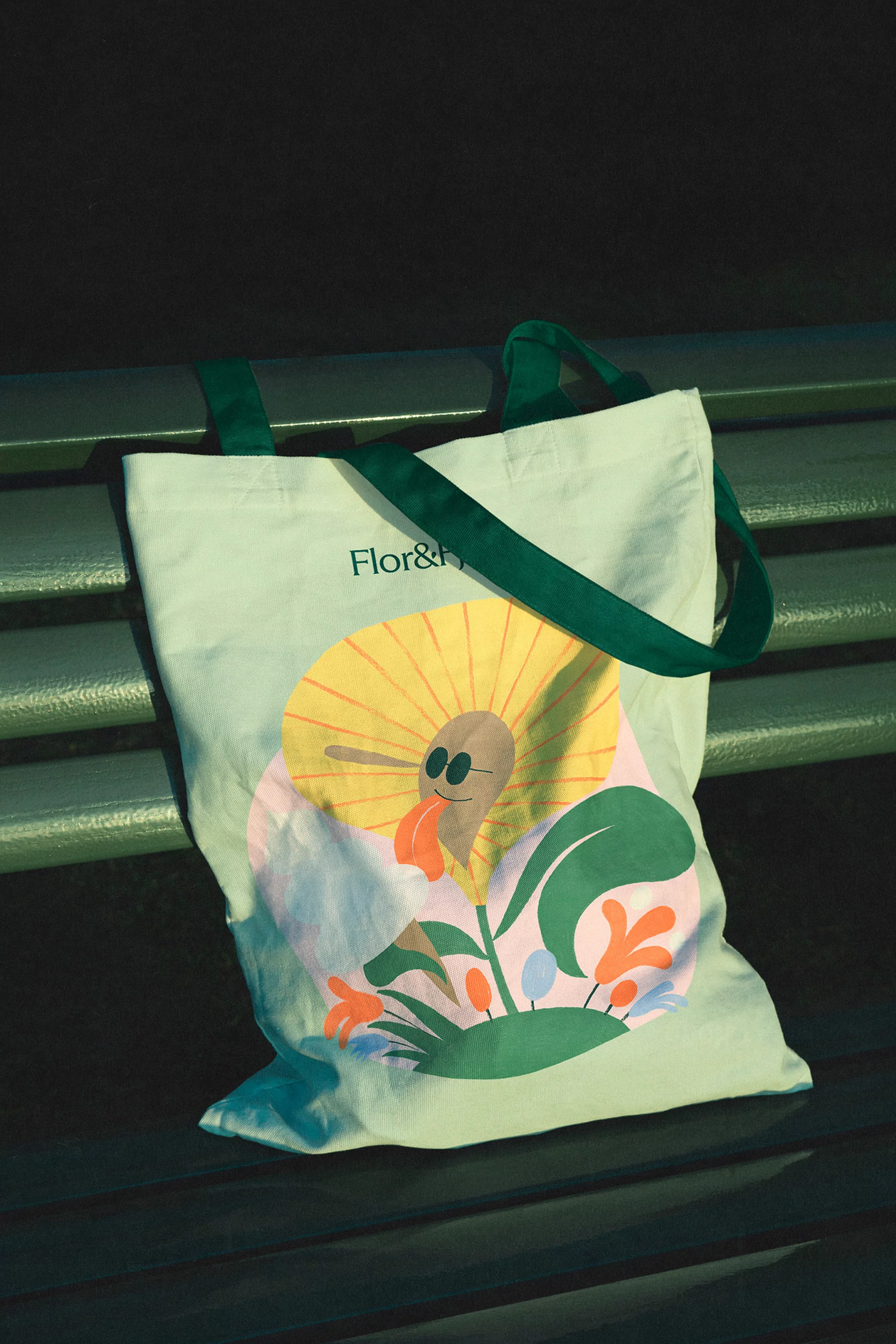 Canvas tote bag featuring a playful cartoon flower design, set against a dark background, ideal for shopping or casual use.