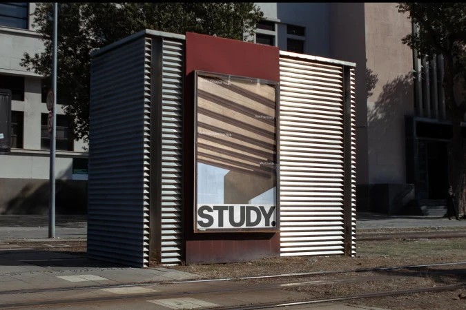 Outdoor study advertisement on a corrugated metal booth, promoting education and San Francisco, featuring modern architectural details.