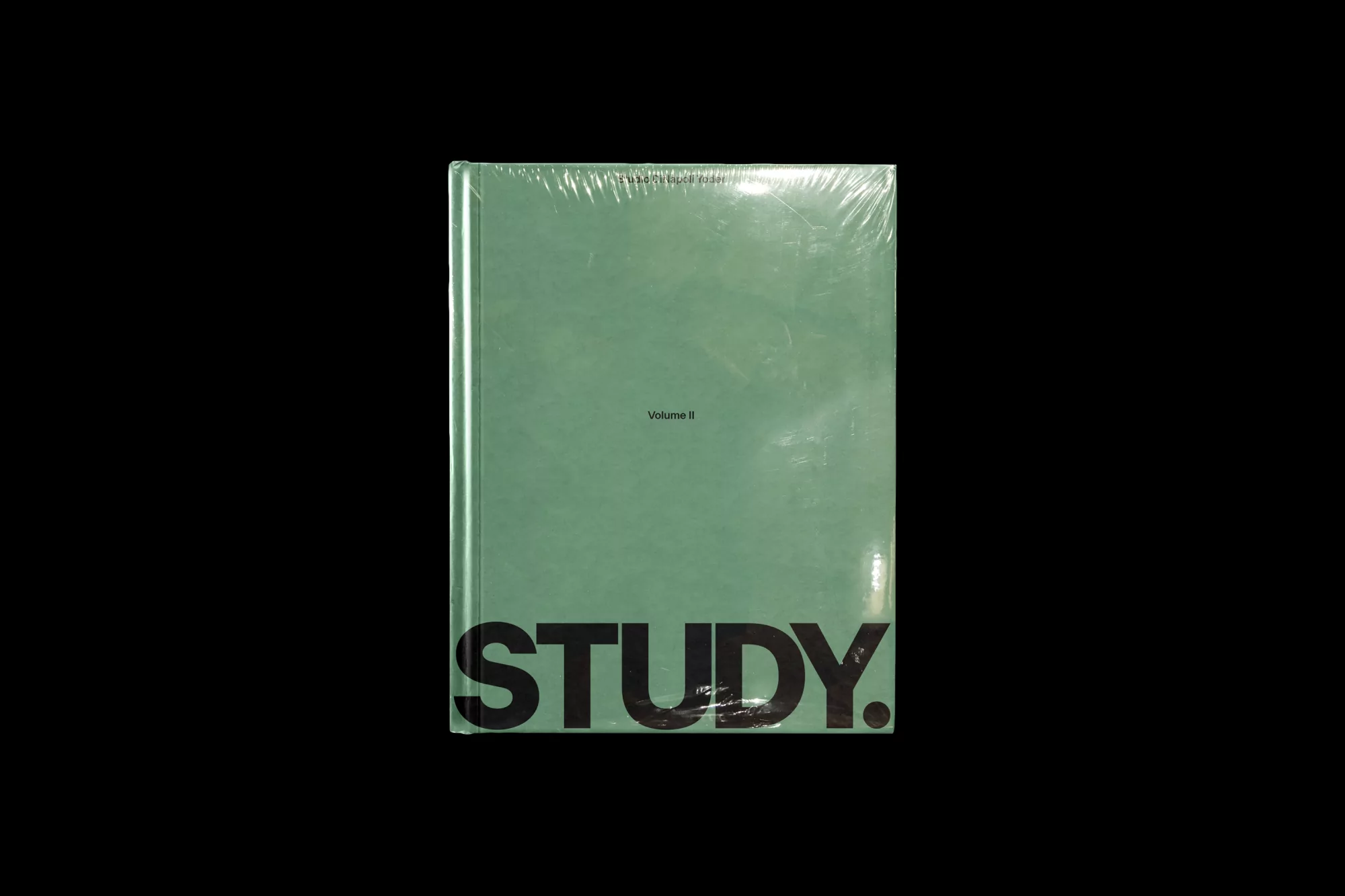 Sealed sage-green book with 'STUDY' in bold black letters on a black backdrop, creating a simple yet impactful design.
